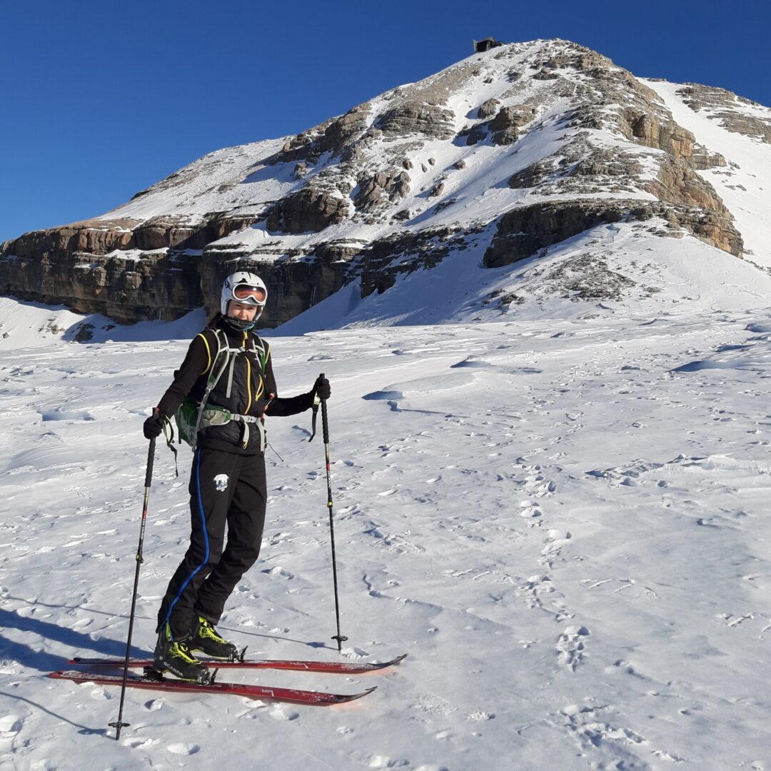 Skier on snowy mountain, sunny day.