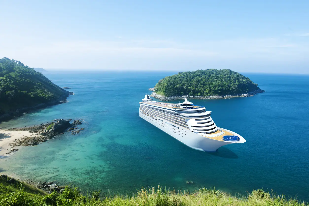 Cruise ship at sea near islands.