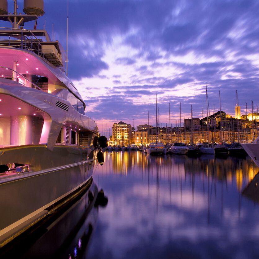 Luxury yacht at sunset in harbor.